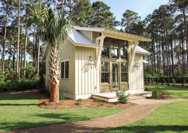 Small cottage-style home with palm tree in front