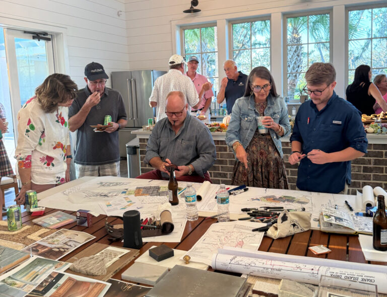 Group of people gathered around a table working on crafts or art