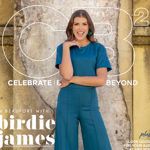CB2 magazine cover with smiling woman in blue dress.