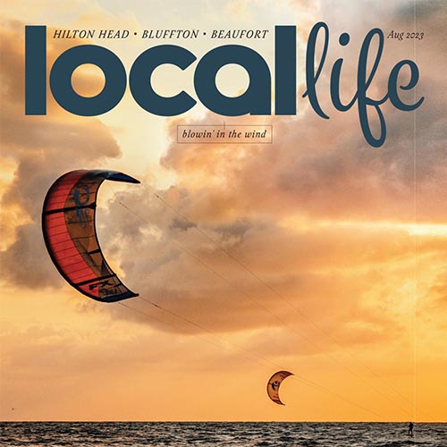 Local Life magazine cover featuring a kitesurfer at sunset.