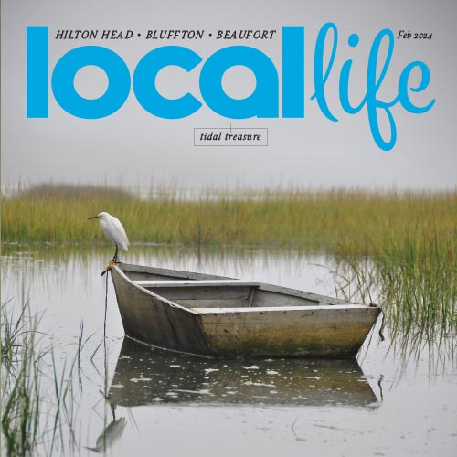 Local Life magazine cover with photo of a canoe floating on calm water.