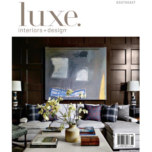 Magazine cover of Luxe Interiors + Design with dark-toned living room.