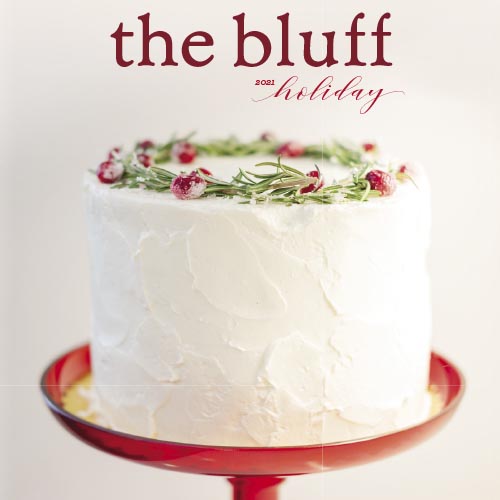 The Bluff magazine holiday edition cover featuring a white cake with berries.