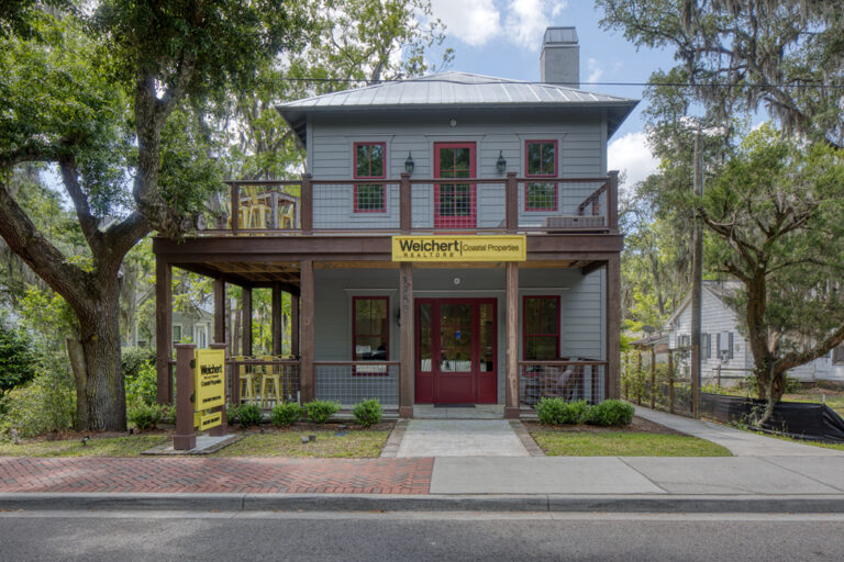 Historic building labeled with front porch and red door.