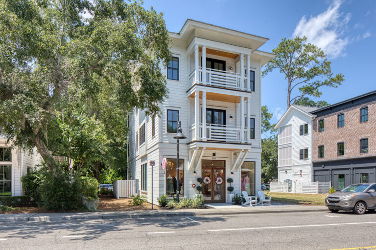 Mixed-use development with deep balconies and decorative brackets.
