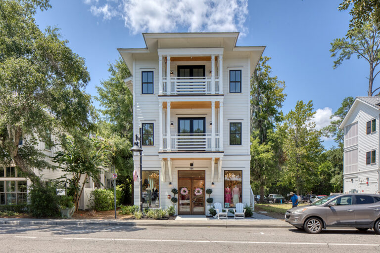 Multi-story commercial building with ground-floor retail and arched window trim.
