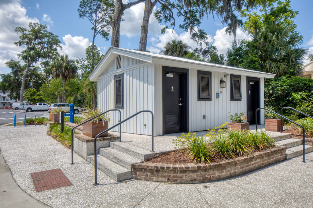 ADA-accessible building with ramp and concrete path in a community setting.