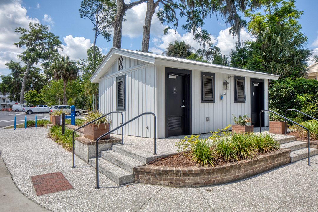 ADA-accessible building with ramp and concrete path in a community setting.