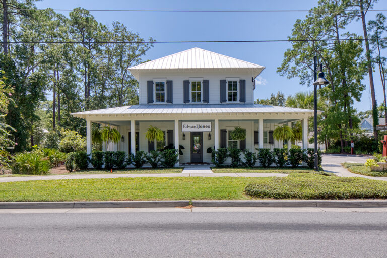Large white Southern-style house with wraparound porch.