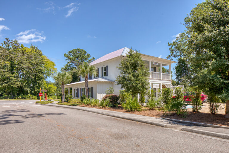 Coastal-style office or civic building with palmetto trees landscaping.