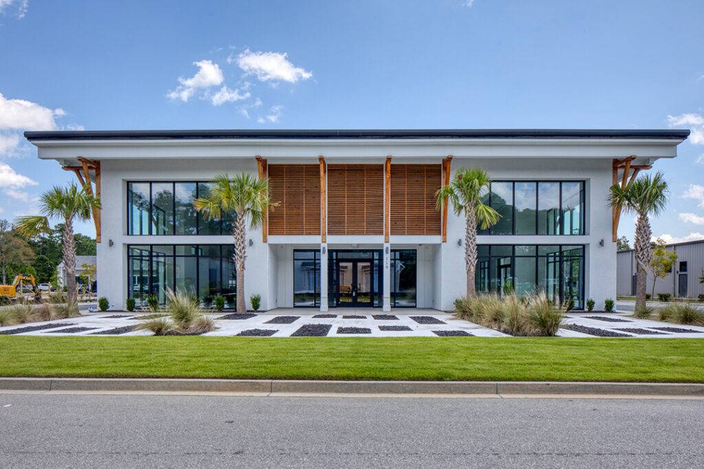 Cottage-style commercial building with picket fence and colorful details.