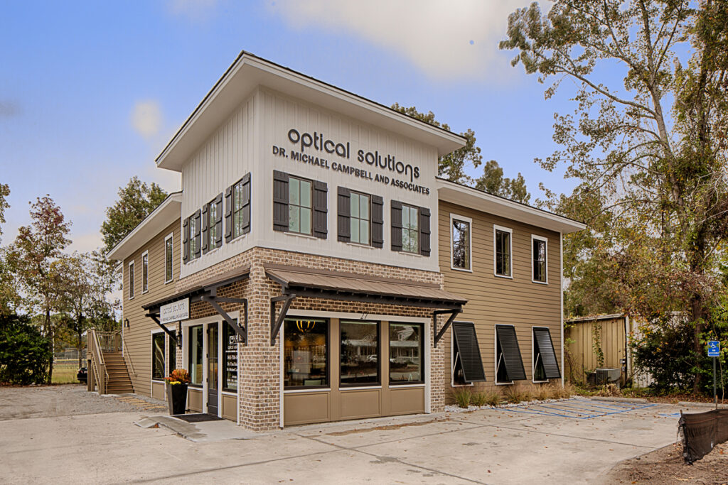 Optical Solutions building with large storefront windows and beige facade.
