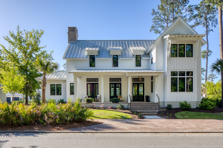 Exterior of a classic white Southern-style home with symmetrical facade.
