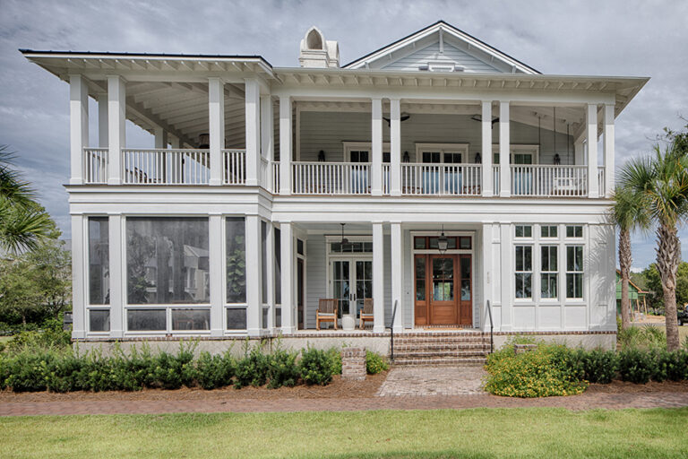 The rear elevation of a classic coastal home with double porches, a central brick staircase, and large screened-in areas for outdoor living.