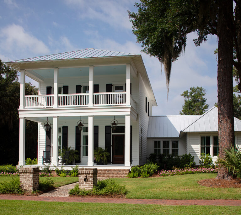 Two-story Southern-style home with large white columns and a wide front porch.